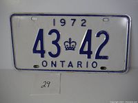 Front view of the 1972 Ontario license plate showing details of the blue numbers, crown symbol, and blue border on white background.