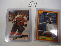 Eric Lindros hockey card and Eric Lindros Toronto Blue Jays baseball rookie card both in protective cases.