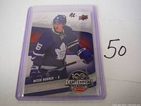 Front of Mitch Marner rookie card showing him in Toronto Maple Leafs jersey and Centennial Classic logo with 'RC' marking.