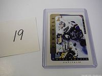 Full view of the Olaf Kolzig Pinnacle hockey card in a protective case with autograph visible