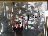 Close-up of central photograph showing Mike Weir celebrating with arms raised and autograph.