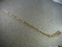 Full length image of vintage Sher-Wood wooden hockey stick showing branding and full stick view