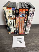 Front view of anime DVD lot showing 11 DVDs with visible titles including Cowboy Bebop, Genso Maden Saiyuki, Death Note, Battle Stage, Stellvia and Zone of the Enders.