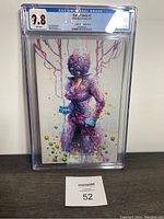 Front view of Out of Body #1 comic book in CGC slab showing vibrant abstract cover art and 9.8 grade label