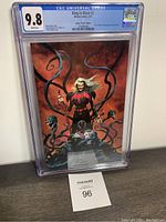 Front view of CGC slabbed King in Black #2 comic, graded 9.8 with vibrant Jerome Opena Virgin Exclusive virgin variant cover art.