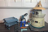 Full view of Jurassic Park Command Compound playset parts including main tower, fences, turrets and signage