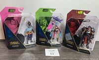 Four unopened League of Legends 1st Edition figures including Yasuo (two figures), Jinx, and Darius displayed side by side.