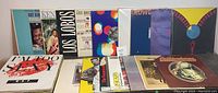 Front view of the lot of mixed vinyl records showing various album covers including Nat King Cole and Los Lobos.
