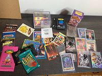 Overview of trading cards including packs and loose cards on table surface