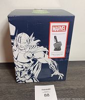 Box with Marvel branding and image of Thor's hammer electric warmer on front and side, blue packaging showing Thor character drawing.