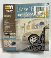 Box of Multy Easy Tile Dry Floor interlocking drainage tiles sealed and labeled with product details.