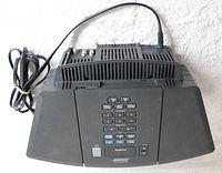 Top view of BOSE Wave Radio unit showing integrated control panel and ventilation with attached power cord.