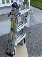 Front view of the folded aluminum Werner ladder showing logo and structure.