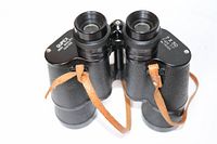 Top view of QUPEX binoculars showing the lens and brand markings on barrels.