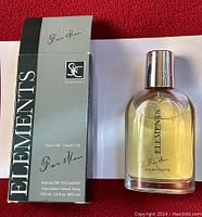 Photo of one Elements for Man men's eau de toilette bottle next to its original black and green box packaging.