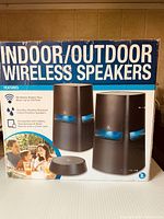 Box showing product image and key features: wireless streaming up to 150 feet, durable, weather resistant speakers compatible with tablets, smartphones, and other devices with 3.5mm jack.