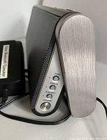 Side view of Sony Bluetooth speaker SRSBTX300 showing control buttons and metal end cap.