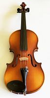 Front view of full size violin showing warm brown finish, strings, bridge, tailpiece and chin rest.