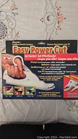 Box of Easy Power Cut Cordless Electric Scissors showing product name, features, and images of scissors cutting various materials including paper, fabric, leather.