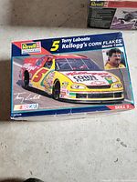 Boxed Revell Monogram model kit featuring Terry Labonte's Kellogg's Corn Flakes Monte Carlo race car at 1:24 scale, showing box art with car image and driver photo.
