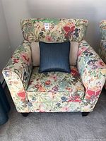 Front view of the floral patterned chair with both cushions in place.