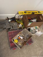 Photo showing Ryobi cordless drill, drill bit sets, screws and hardware in plastic organizers