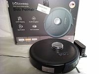 Front view showing boxed product, robot unit and charging dock