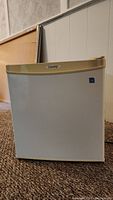 Front view of a white Danby mini fridge with gold top trim and Energy Star sticker.