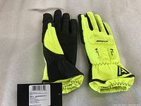 Pair of yellow and black rescue extrication gloves laid flat, showing dorsal and palm sides with elastic wrist cuffs and padded knuckles, with visible ActivArmr branding.