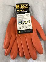 Pair of Ringers Gloves R-Flex Cut Resistant gloves with label attached describing features.