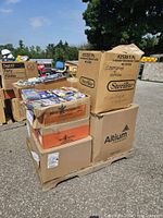 Boxes on pallet containing Halloween costume makeup, face paint and fake teeth in original packaging.