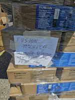 Pallet of sealed boxes labeled Fusion Touchless Sanitizer Dispensers with handwritten note indicating 21 new pieces.