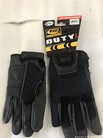Black Ringers Law Enforcement Duty gloves laid flat showing front view with padding, stitching and closure features.