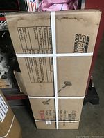 Photo of the original cardboard packaging of the SRT Barbell showing branding, model name, and product origin information.