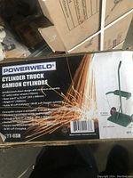 Box front showing Powerweld brand name, model VT-6SH, and detailed specs of welding cylinder cart.