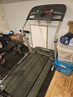Full view of the Weslo I330 treadmill showing the running surface, handrails, and control panel, indicating foldable design and condition.