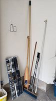 Photo showing the wooden oar, broom, ski poles, and the Wooster Sherlock extension pole all grouped together.