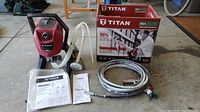 Full lot contents laid out: sprayer unit, box, manual, hoses and spray gun
