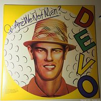 Front cover of DEVO Are We Not Men LP featuring stylized portrait and DEVO logo on yellow background.