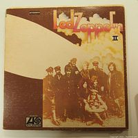 Front cover of Led Zeppelin II vinyl LP record showing title, band name, and group photo artwork with clouds background.