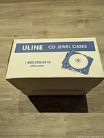 Closed box labeled Uline CD Jewel Cases with Uline contact number and logo visible