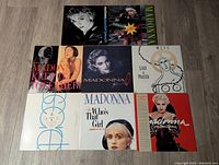 Top view of eight Madonna vinyl single covers arranged in two rows showing front cover artwork and title.