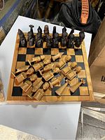 Chessboard with light and dark wooden chess pieces arranged on the board
