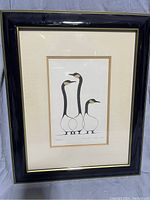Framed art print of three stylized birds in black and white inside a black frame.