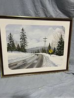 Framed painting of snowy road with trees, telephone poles, and a curve sign. Signed by Craig, dated 1973.