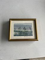 Framed watercolor painting of marsh with cattails and water, signed "RA Harold".