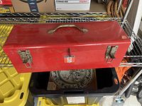 Red vintage Mastercraft metal toolbox closed, showing latches and handle.
