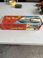 Original box for battery operated toy tug boat with colorful graphics and model info.