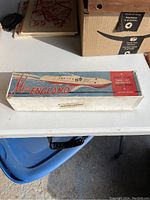Closed original box with vintage design and 'Miss England' labeling on table.