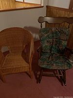 Both chairs shown side by side, wicker chair on left, wooden cushioned rocking chair on right.